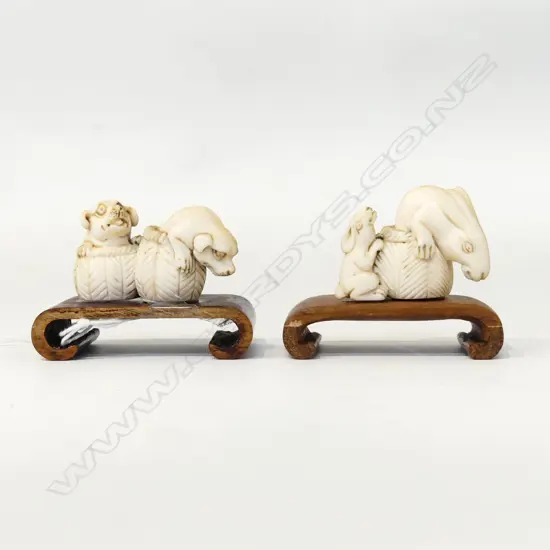 2 ORIENTAL CARVED IVORY NETSUKE; PUPPIES & RABBITS IN BASKETS W.50mm