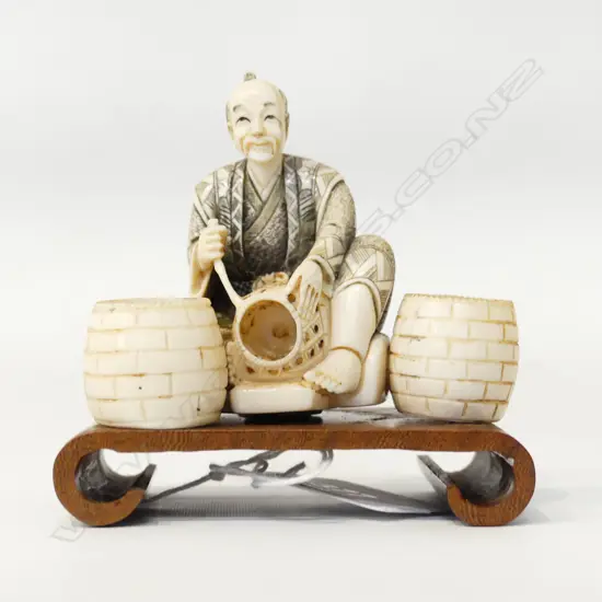 ORIENTAL CARVED IVORY NETSUKE; MAN w. BASKETS W.80mm