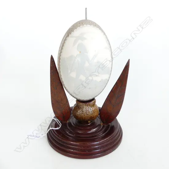 CARVED ANTIQUE EMU EGG OF ABORIGINAL MAN, KANGAROOS FAUNA & FLORA MOUNTED ON WOODEN STAND H. 230mm