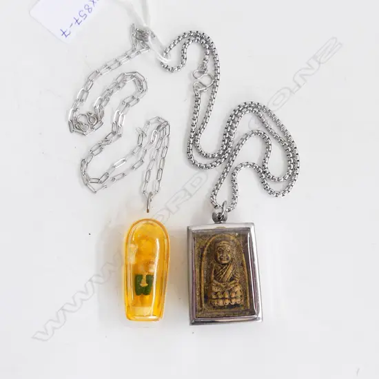 2 AMULETS (1 WITH HOLY OIL),  BOTH ON STAINLESS STEEL CHAINS. 