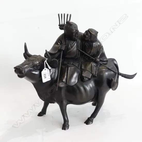 BRONZE ELDERLY COUPLE RETURNING FROM WORK ASTRIDE AN OX H.356mm