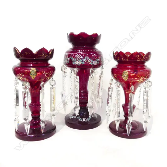 THREE VICTORIAN LUSTRE VASES. ALL RUBY COLORED ONE PAIR ( ONE LUSTRE BROKEN) AND ONE TALLER. TALLEST 365 PR 300mm HIGH.