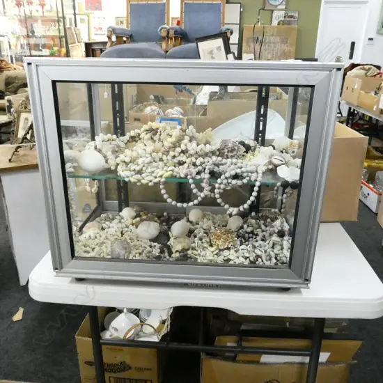 GLASS & ALUMINIUM DISPLAY CABINET, SLIDING DOORS, 2 SHELVES FULL OF ASST SHELL NECKLACES & SHELLS  500 X 310 X 400mm