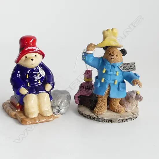 2 PADDINGTON BEAR 'AT THE STATION' FIGURES; 1 BESWICK (H.85mm) & 1 ROYAL DOULTON (H. 105mm)