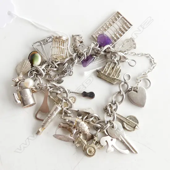 SILVER VINTAGE CHARM BRACELET includes nz charms 61gms