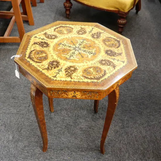 INLAID OCTAGONAL OCCASIONAL TABLE DECORATED IN THE ITALIAN MANNER WITH INCORPORATED MUSIC BOX. 450X560mm