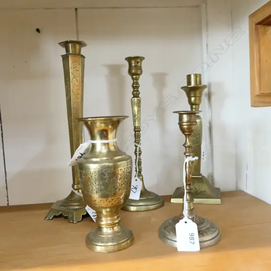 FIVE 'INDIAN STYLE ' BRASS CANDLESTICKS WITH ENGRAVED DETAIL. TALLEST 270 SHORTEST 150mm