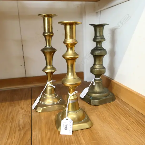 THREE BALUSTER SHAPED OLD BRASS CANDLESTICKS. APPROX 220mm HIGH 