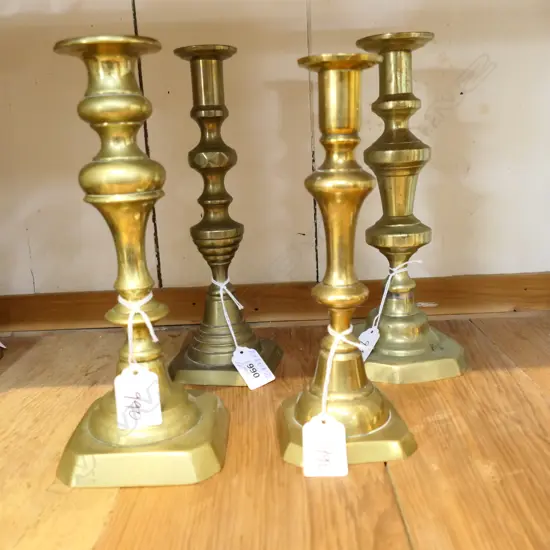 FOUR BALUSTER SHAPED OLD BRASS CANDLESTICKS. ALL APPROX 250mm HIGH 