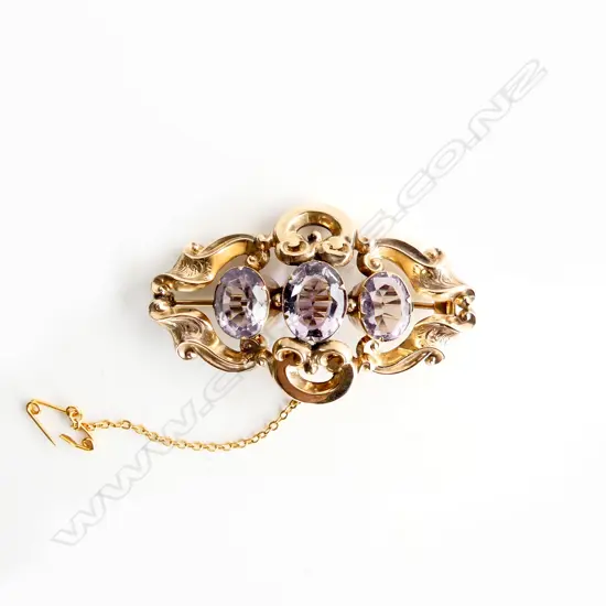 A Victorian 9ct gold 3 stone amethyst brooch