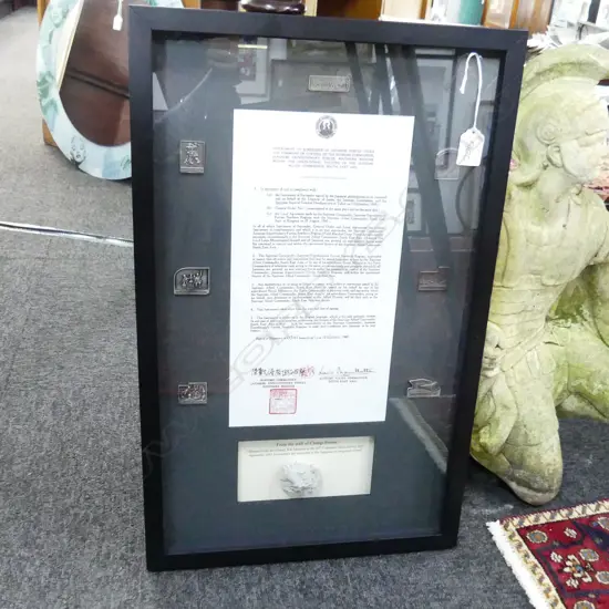 FRAMED PIECE 'FROM THE WALL OF CHANGI PRISON' with copy of letter detailing surrender of Japanese forces etc 
