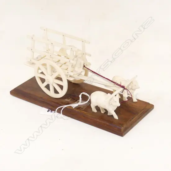 VINTAGE IVORY OX DRAWN CART WITH FIGURE ON WOODEN PLINTH, L.175MM