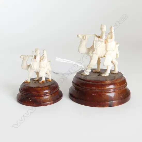 2 SMALL IVORY CARVED CAMELS ON WOODEN STANDS H 70 MM