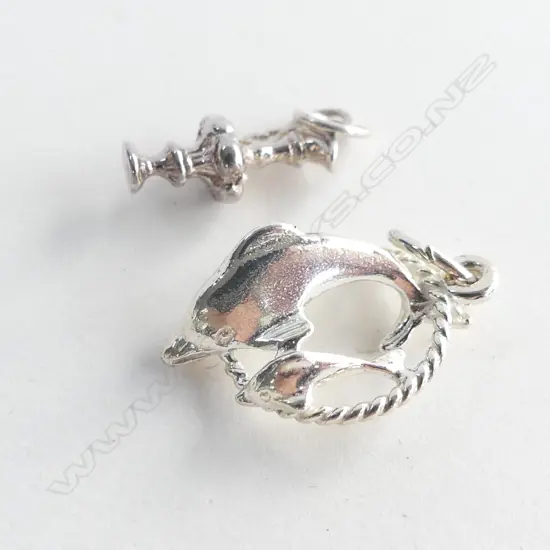 TWO STG SILVER CHARMS; AMERICA'S CUP TROPHY (?) & DOLPHIN WITH HOOP 3.17GMS 
