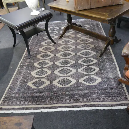 PAKISTANI BOKHARA HANDKNOTTED WOOL PILE RUG; many medallions on pale tan ground 2750x1730mm