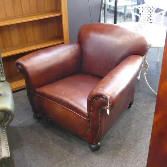 VINTAGE BROWN LEATHER ROLL ARM CHAIR - WHEELS ON BACK LEGS