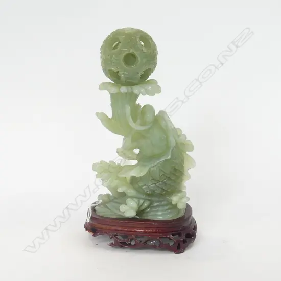 ORIENTAL JADE CARVED SCULPTURE WITH PUZZLE BALL, ON WOODEN STAND H. 210MM (BASE OF STAND A/F)