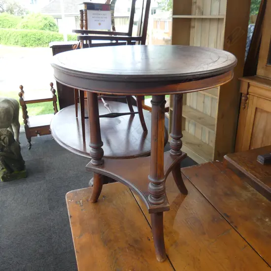 CIRCULAR COLONIAL KAURI TABLE ON TREFOIL STRETCHER AND SPLAY LEGS.H.700mm D.620mm