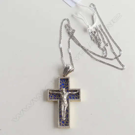 A 14k white gold and diamond crucifix on 14k gold chain,