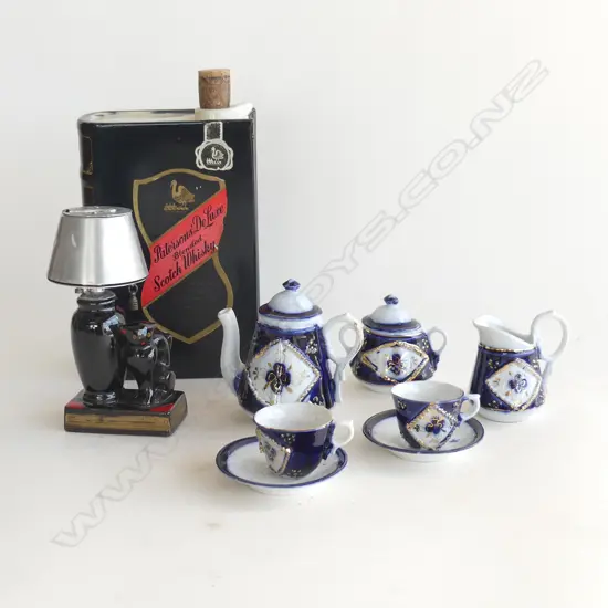 ASST COLLECTABLES; RED GLASS CAT LAMP TABLE LIGHTER, PATERSONS WHISKY 'BOOK DECANTER' & MINIATURE 7PC COBALT TEA SET 