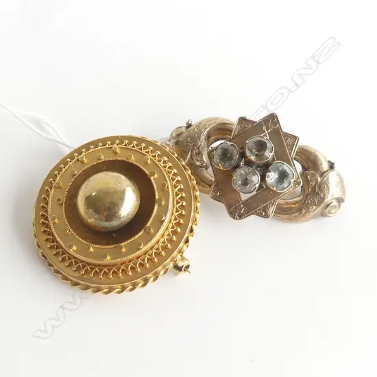 2 VICTORIAN GOLD METAL BROOCHES. the Victorian round brooch testing as 14ct