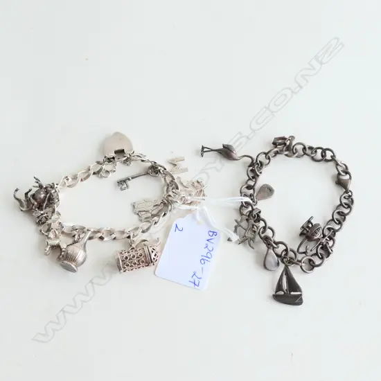 2 STG SILVER CHARM BRACELETS WITH CHARMS 58.62GMS