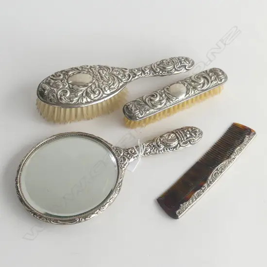 4 PCE SILVER BACKED VANITY SET: hand mirror + 2 brushes + comb . Embossed w masks etc 