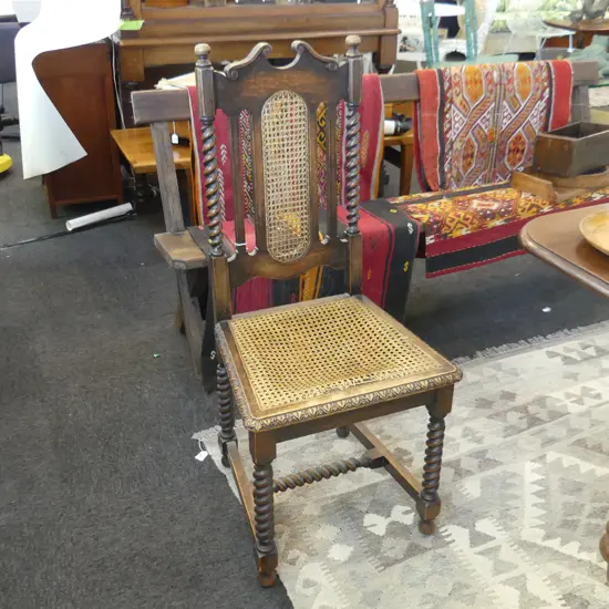 ONE JACOBEAN STYLE OAK CHAIR THE CANE FAULTED