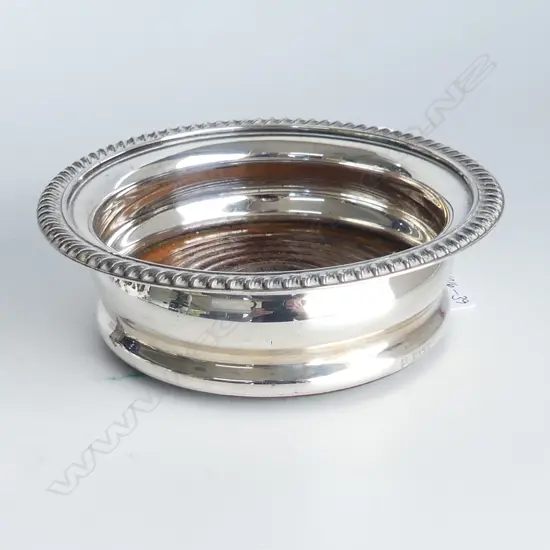 A silver wine coaster,