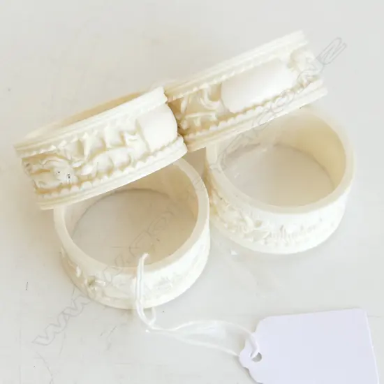 FOUR IVORY CARVED NAPKIN RINGS