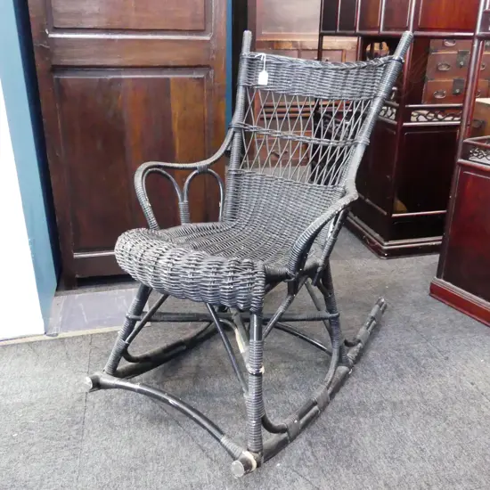 BLACK PAINTED CANE ROCKING CHAIR