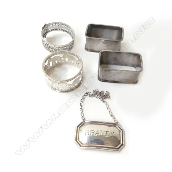 3 STG SILVER NAPKIN RINGS (+1 EP) + STG BRANDY DECANTER LABEL, B'HAM 1940 67gms
