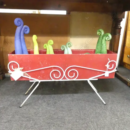 CAROLYN HODGSON CERAMIC KORUS IN A VINTAGE PLANTER