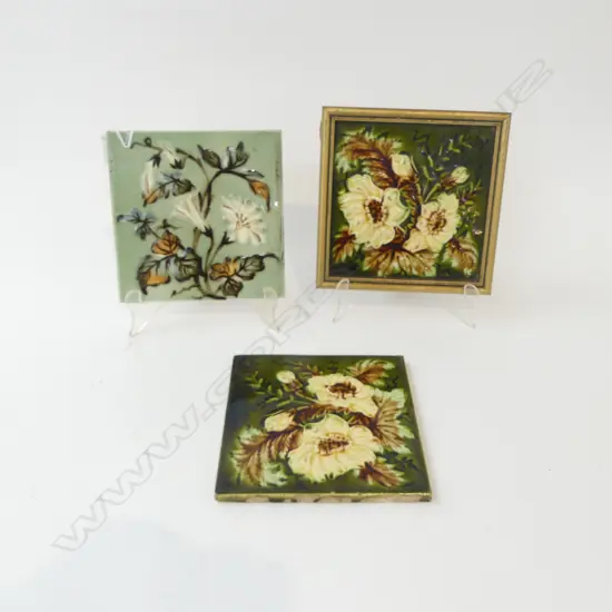 THREE ANTIQUE MAJOLICA GLAZED FLORAL TILES (ONE IN FRAME) 150MM SQ
