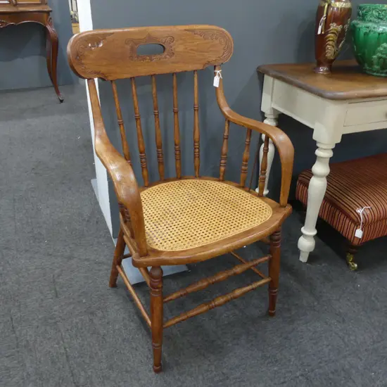 EARLY 20thC OAK SPINDLE BACK ARM CHAIR; CANED SEAT