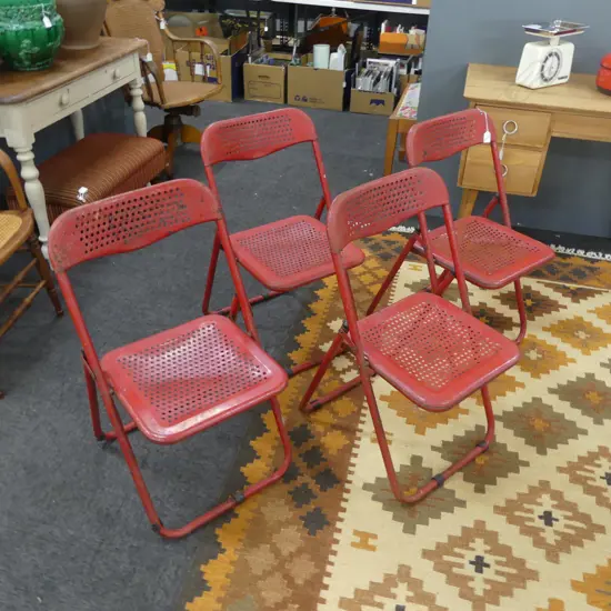 4 RED METAL FOLDING CHAIRS