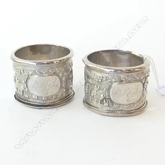 PAIR OF CHINESE STERLING SILVER SUBSTANTIAL NAPKIN RINGS WITH HEAVILY EMBOSSED VILLAGE SCENES, CHINESE HALLMARKS 130GRAM
