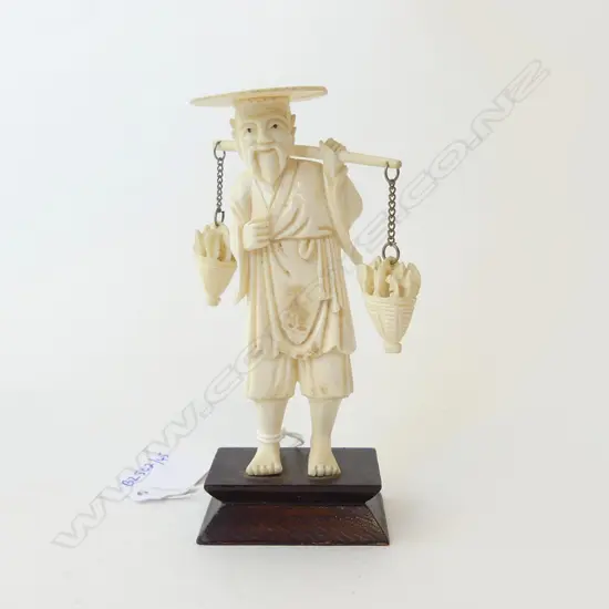 IVORY CARVED FISHERMAN CARRYING BASKETS OF FISH ON WOODEN MOUNT (REPAIR TO HAT) H.120MM