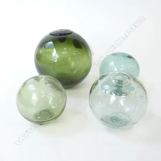 FOUR VINTAGE JAPANESE GLASS FISHING FLOATS IN GREEN/AQUA D.130MM-70MM  