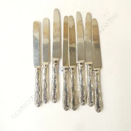 EIGHT AMERICAN STERLING SILVER HANDLED KNIVES (blades possibly silver plate but pitted)