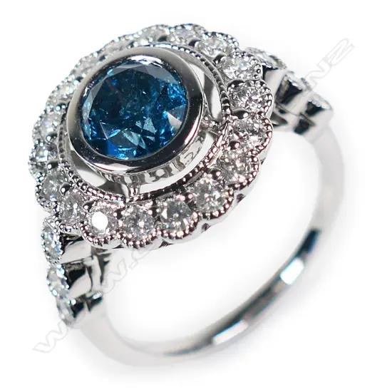 A 14ct white gold blue diamond antique style halo ring,