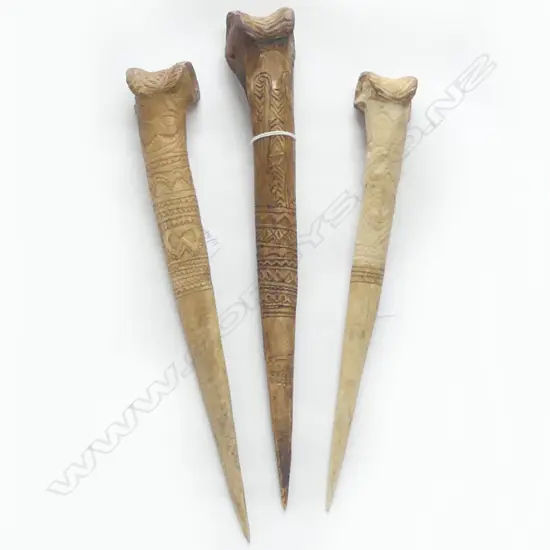 THREE P,N.G CASSOWARY BONE DAGGERS WITH INCISED DECORATION L 390 MM