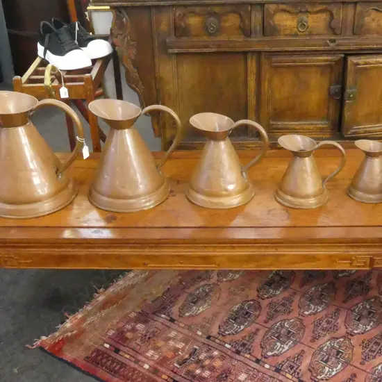 5 GRADUATING COPPER JUGS H.310mm