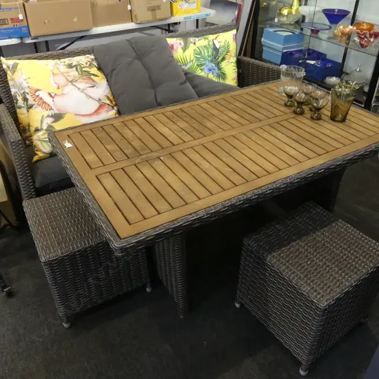 4 piece outdoor patio suite, woven plastic cane, 3 seater,  table & 2 stools. With loose cushions