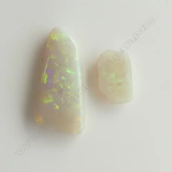 2 UNSET OPAL GEM STONES: the larger 25 x 12mm approx with good fire & red tone