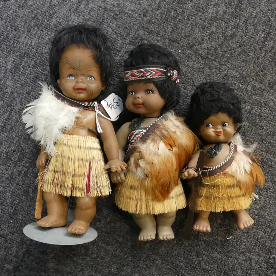 3 VINTAGE RUBBER MAORI DOLLS wearing flax piupiu & feather capes with taniko bands Tallest H.220mm