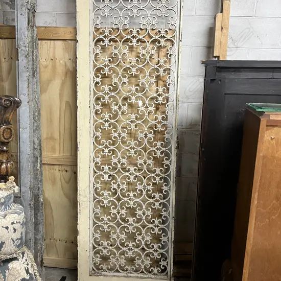 LGE SINGLE FRENCH METAL GRILLE DOOR. Scrolling quatrefoil motif repeating. In wood frame. 2275 x 690mm