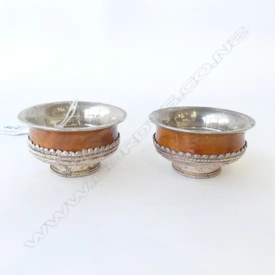 PAIR OF TIBETAN SILVER AND WOOD SALTS