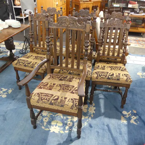 7 JACOBEAN STYLE OAK DINING CHAIRS, 1 A CARVER