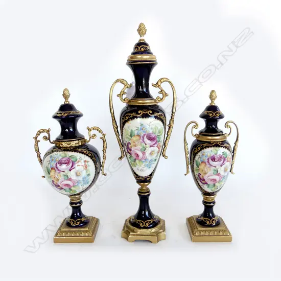 3 SEVRES PORCELAIN & ORMOLU URNS floral panels on cobalt ground signed. Tallest 310mm.